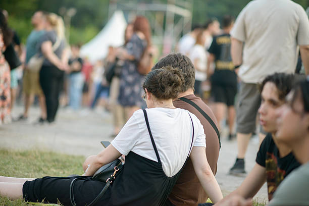 Sofia, Bulgaria  June 25, 2025. A young couple sits on the grass surrounded by people in a public outdoor area in Sofia, Bulgaria, during a relaxed summer evening gathering.