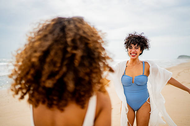istock Young woman having fun with friends on the beach 2242992116