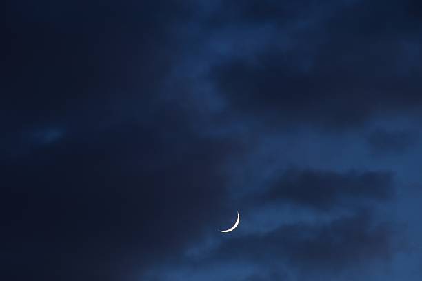 istock half moon floating on dark blue sky in twilight 2242992256