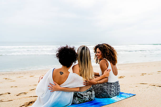istock Young friends women talking on the beach 2242993193
