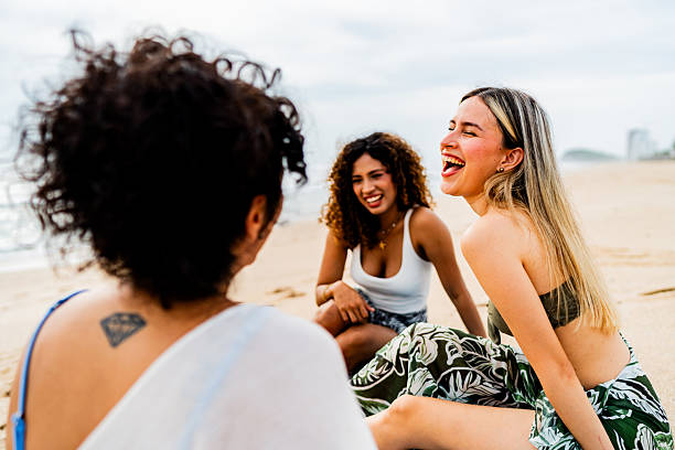 istock Young friends women talking on the beach 2242993244