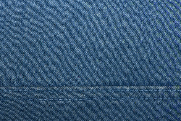Denim fabric with blue thread seams, denim jacket, denim pants, for background or fabric sample sale. Thread seam on denim.