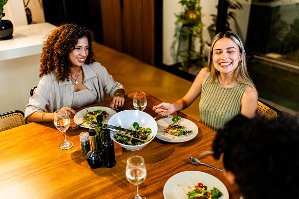 istock Young friends women talking during dinner at home 2242994418