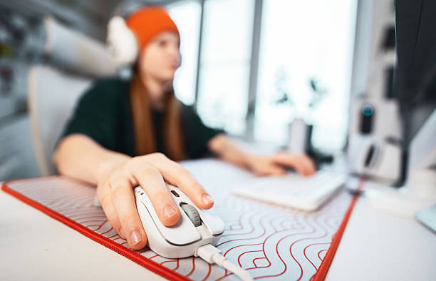 asian young pro gamer girl playing in online video game at home and talking with teammate