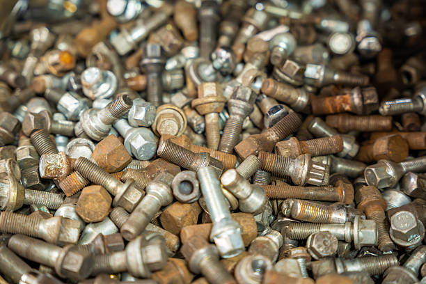 istock Collection of various car wheel nuts scattered on a surface, including new, rusty, and used ones. Automotive maintenance background symbolizing wear, repair, and seasonal change. 2242997882