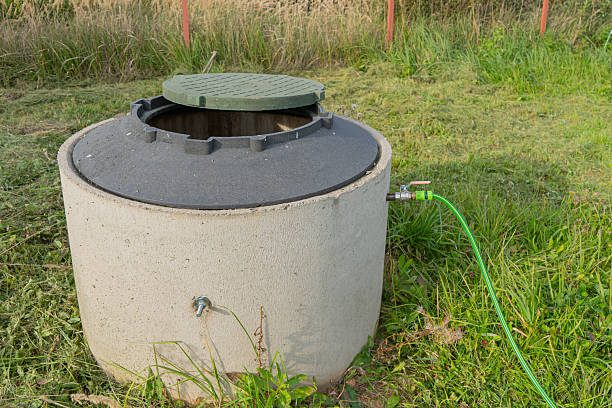 istock Concrete well ring with water hose. 2242997982