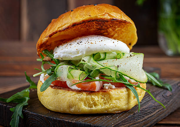 istock Bun breakfast sandwich with salt salmon, cream cheese and poached egg 2242999009