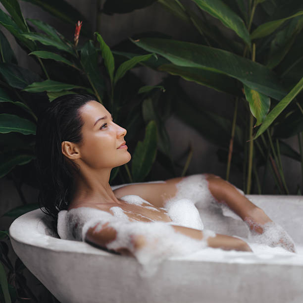 istock Relaxed Woman Enjoying a Luxurious Bubble Bath in Tropical Ambiance 2243000785