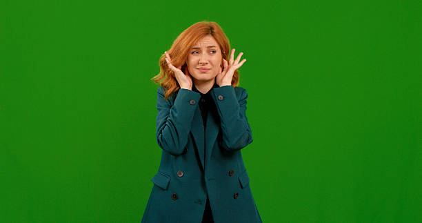 istock Woman expressing various gestures in front of a green screen backdrop 2243000943