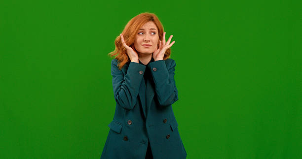 istock Woman demonstrates various hand gestures in a studio with a green backdrop 2243001045