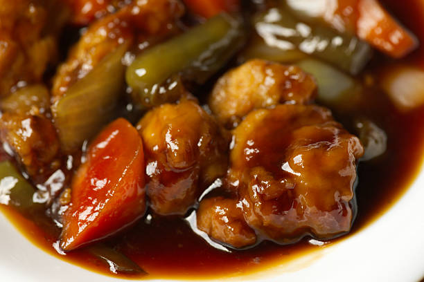 A plate full of sweet and sour pork.