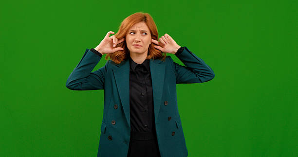 istock Woman shows various gestures expressing emotions against green screen backdrop 2243001511