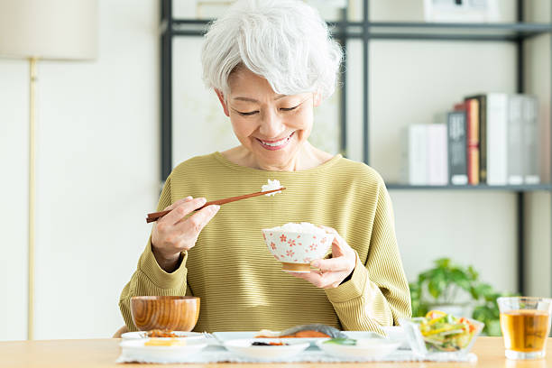 istock Senior woman eating breakfast 2243002240