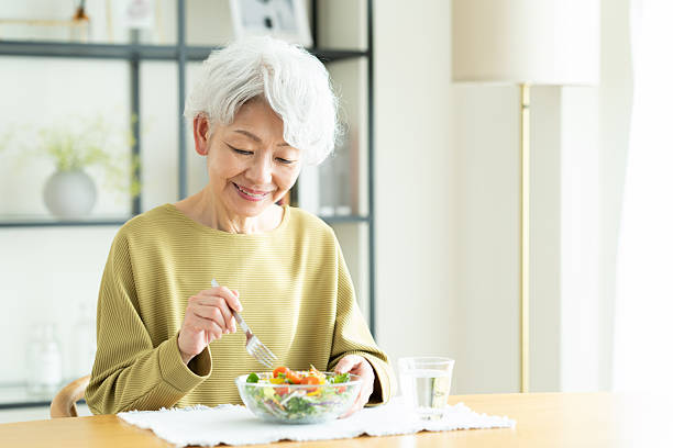 istock Senior woman eating salad 2243002268