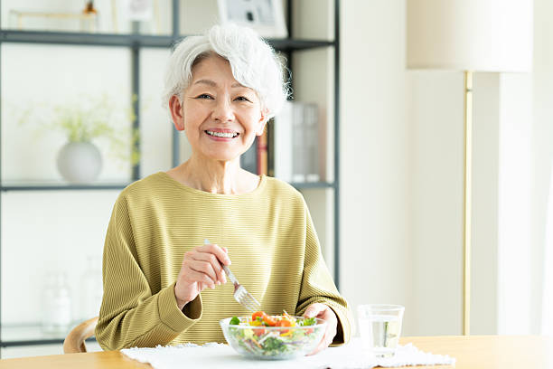 istock Senior woman eating salad 2243002271