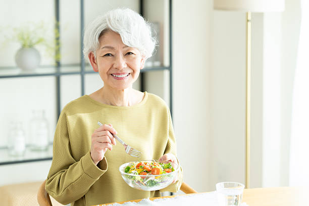istock Senior woman eating salad 2243002275