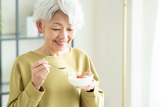 istock Senior woman eating yogurt 2243002285