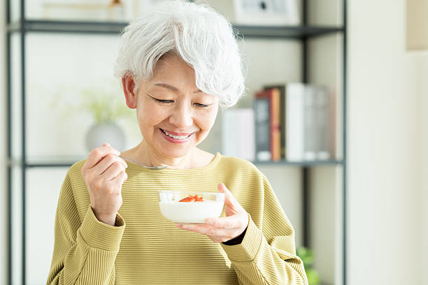 istock Senior woman eating yogurt 2243002291