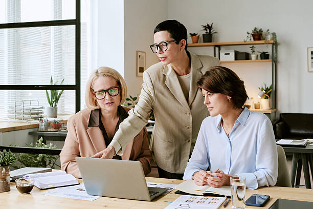 istock Middle Aged Women Reviewing Digital Presentation during Office Collaboration 2243002447