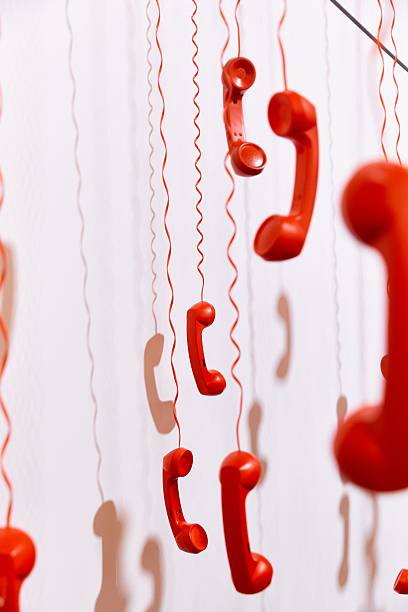 istock Artistic hanging red telephones installation. 2243002555