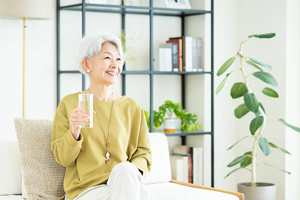istock Senior woman drinking water 2243003494