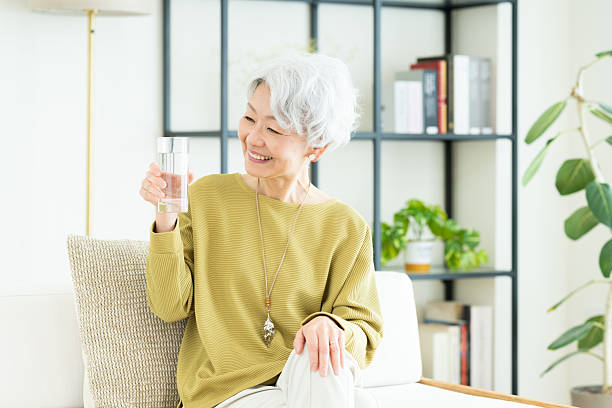 istock Senior woman drinking water 2243003853