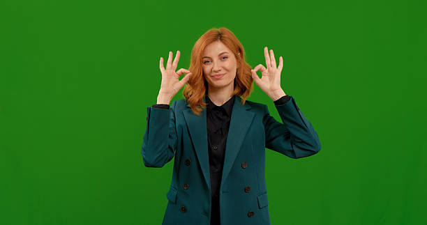 istock Woman demonstrates various hand gestures on a green screen background 2243004412