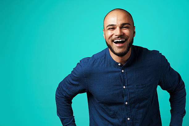 istock Joyful dark-skinned man laughing against turquoise background 2243005973