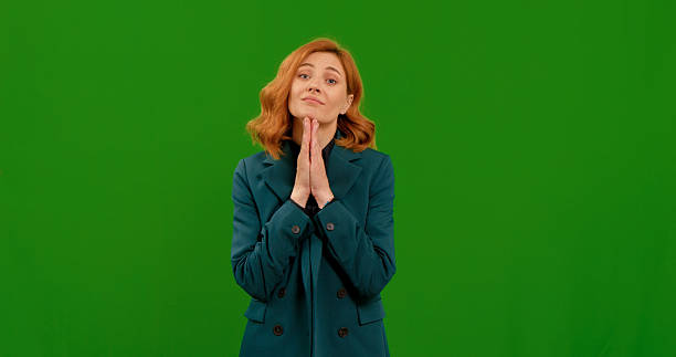 istock Young woman looking asking with hopeful expression of begging on green screen background. 2243006702