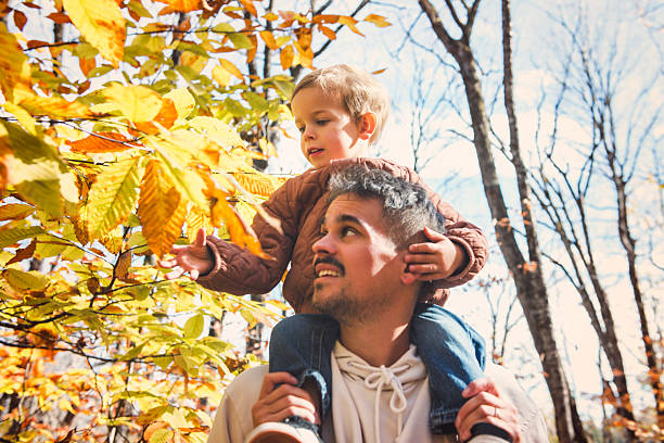 A father with little boy in autumn beautiful forest
