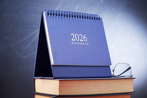 istock 2026 desk calendar and eyeglasses on book 2243007905