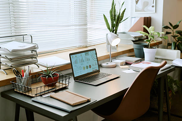 istock Modern Home Office Desk Featuring Laptop Displaying Business Analytics Charts 2243008090