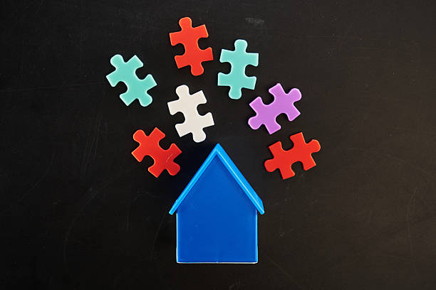 jigsaw puzzles on top of small house model.