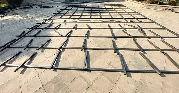 istock Mid Stage Metal Grid Structure Assembly on Outdoor Tiled Patio 2243008779