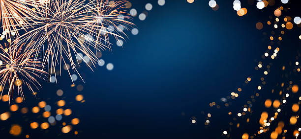 istock Blue and gold fireworks and bokeh lights on a blue background. Abstract background on Christmas or New Years or 4th of July Eve. Empty background. 2243013061