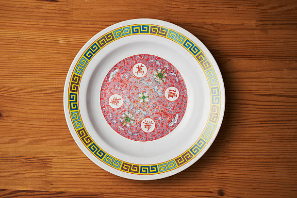 top view of Chinese design printed empty plate on wood table