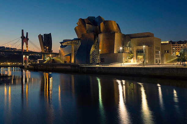 Night view of the Guggenheim Museum on the shore of the Nervión river in Bilbao.