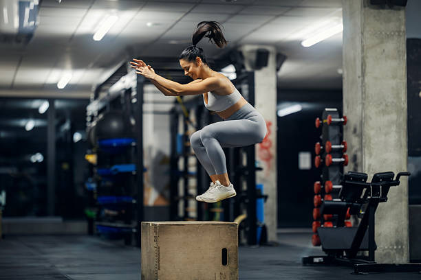 istock Woman doing box jump exercise in gym 2243015578