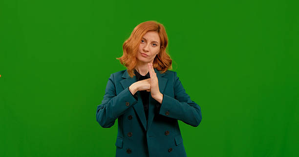 istock Woman demonstrating various gestures in front of a green background 2243015598
