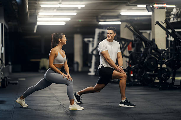 istock Couple stretching together during gym workout 2243015824