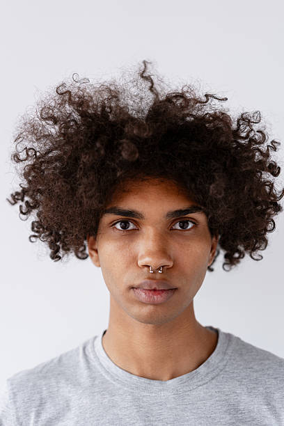 istock Young Black man with curly hair and nose piercing 2243015857