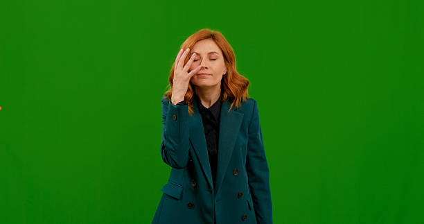 istock Woman demonstrating various hand gestures in a studio with green background 2243016389