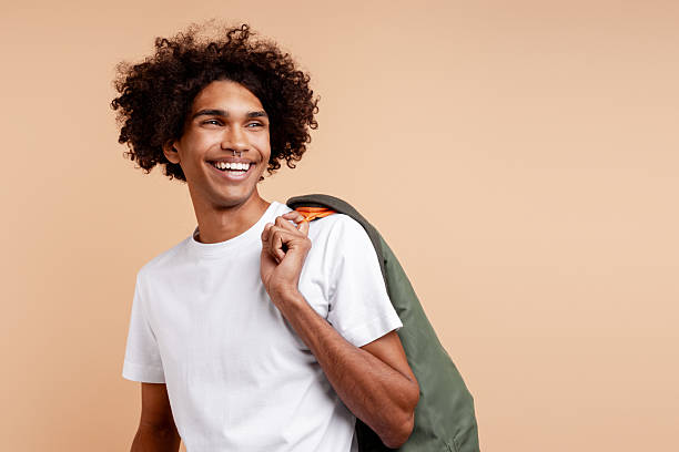 istock Happy young adult man smiling looking away 2243016691