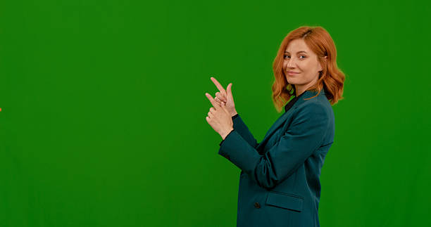 istock Woman demonstrates various gestures in front of green screen background 2243016881
