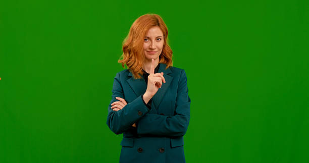 istock Young woman pointing finger scold at someone or warn gesture. 2243017045