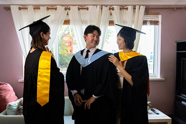 istock Trio in Academic Dress Preparing for University Graduation 2243017680