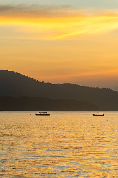 istock glowing horizon over calm backwater with boats at evening sunset 2243019367