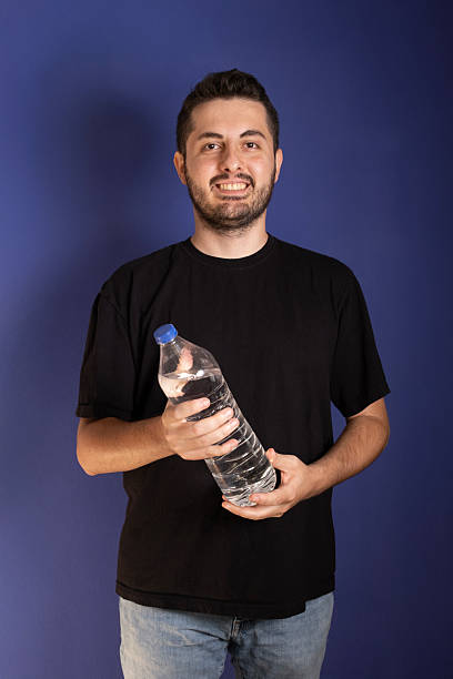 istock Thirsty man drinking water from bottle and looking refreshed 2243022816