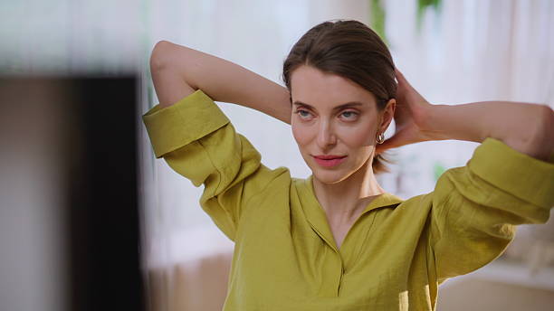 istock Smiling lady making ponytail looking mirror in modern apartment closeup. 2243022899