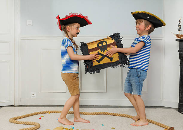 istock Pirate kids pass treasure chest to each other during adventure 2243024582